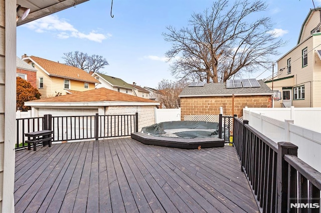 wooden terrace featuring a hot tub