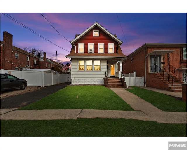 view of front of property with a lawn