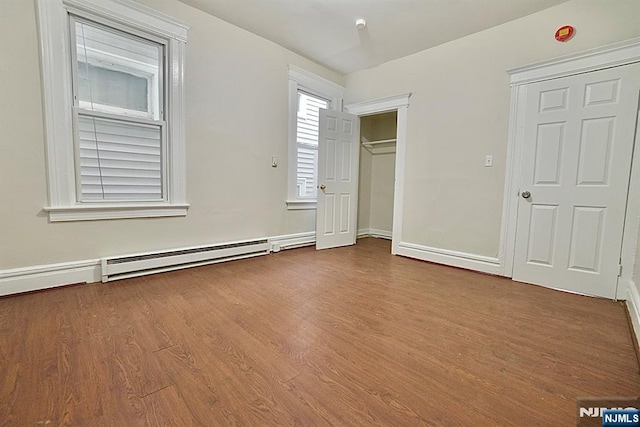 unfurnished bedroom with hardwood / wood-style floors and a closet