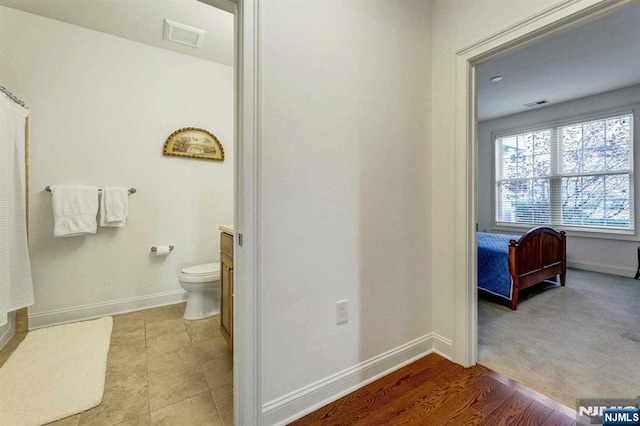 bathroom with tile patterned floors, vanity, and toilet