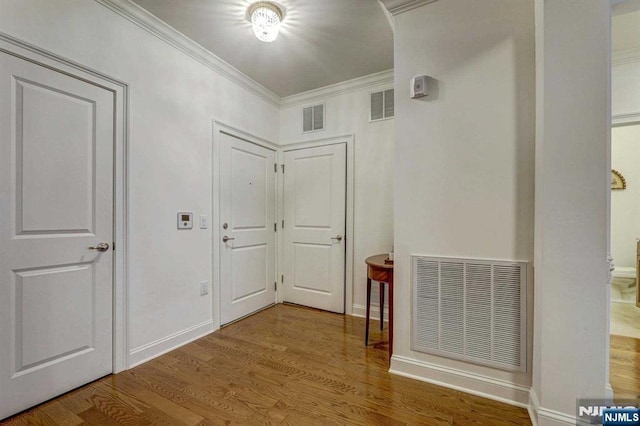 hall featuring hardwood / wood-style flooring and crown molding