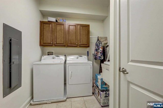 washroom featuring cabinets, electric panel, washer and clothes dryer, and light tile patterned floors