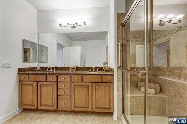 bathroom with vanity, tile patterned floors, and a shower with shower door