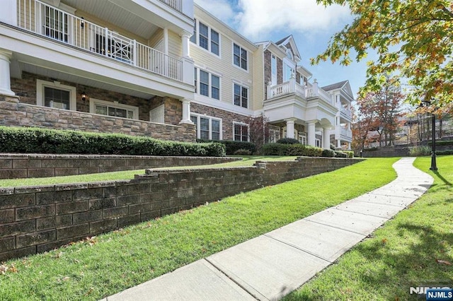 view of property's community with a lawn