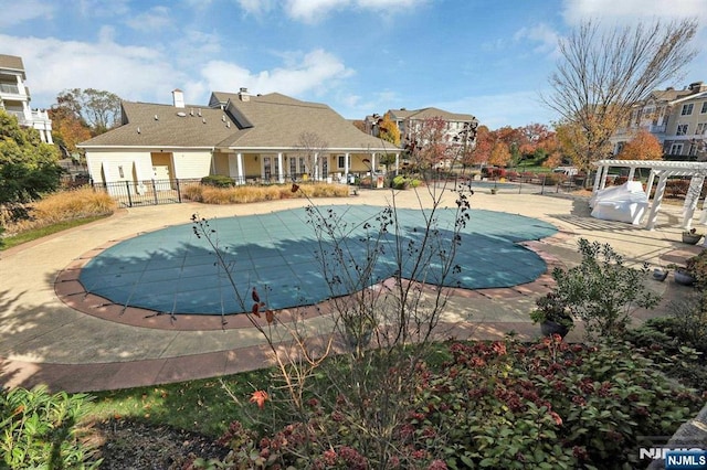 view of swimming pool with a patio and a pergola