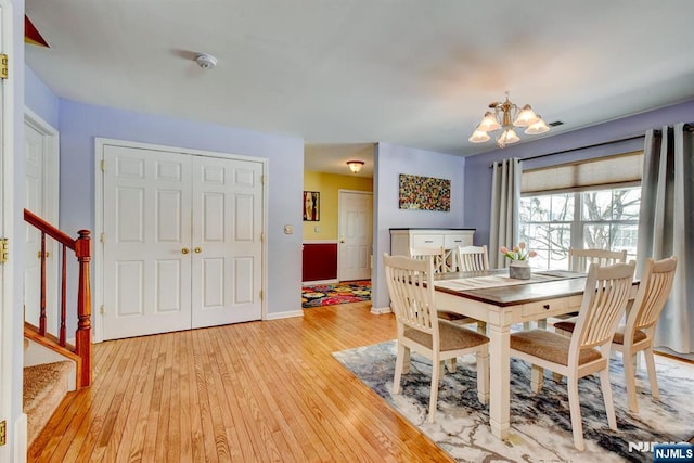 dining room with a chandelier and light hardwood / wood-style flooring