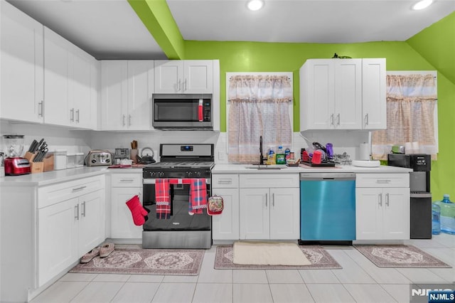 kitchen with white cabinetry, appliances with stainless steel finishes, and sink