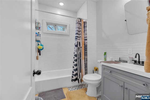 full bathroom featuring tile patterned flooring, shower / bath combo, vanity, and toilet