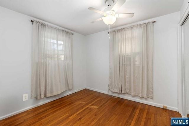 spare room with hardwood / wood-style flooring and ceiling fan