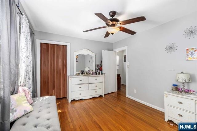 bedroom with ceiling fan and light hardwood / wood-style flooring