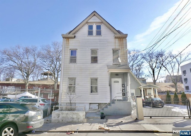 view of front of house featuring fence