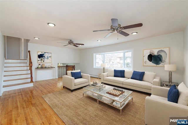 living room with wood-type flooring and baseboard heating