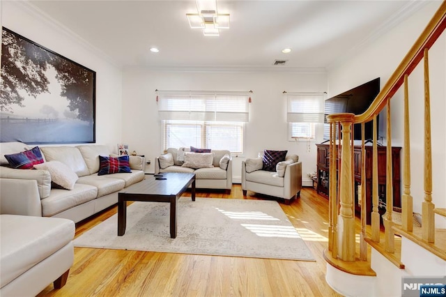 living room with hardwood / wood-style flooring and ornamental molding