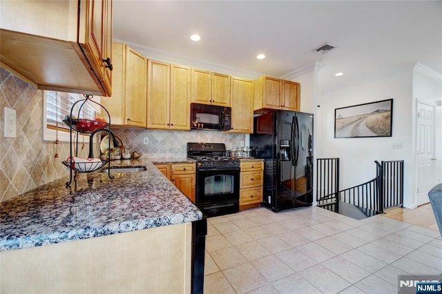 kitchen featuring sink, light stone counters, crown molding, decorative backsplash, and black appliances