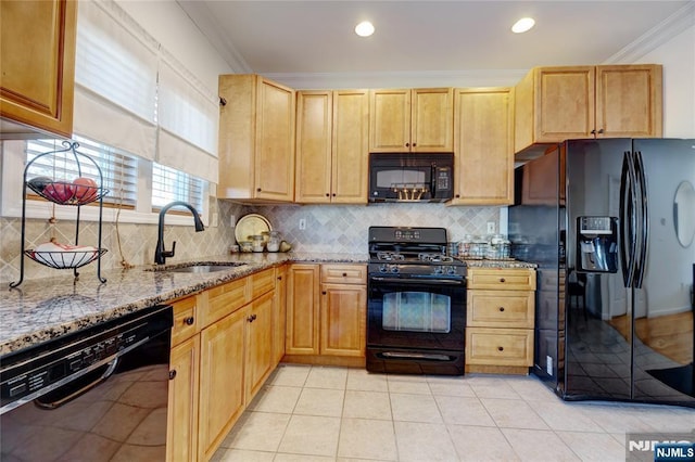 kitchen with sink, light stone counters, crown molding, light tile patterned floors, and black appliances