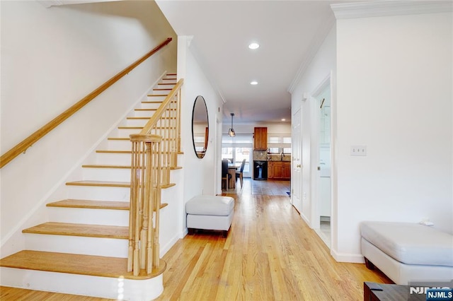 stairway featuring hardwood / wood-style flooring and crown molding