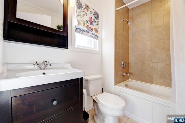 full bathroom with tiled shower / bath, vanity, and toilet