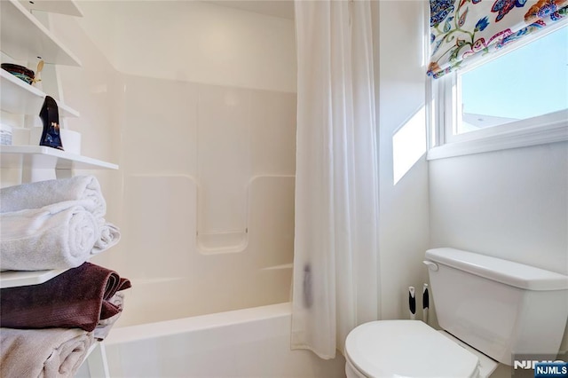 bathroom with toilet and shower / bath combo with shower curtain