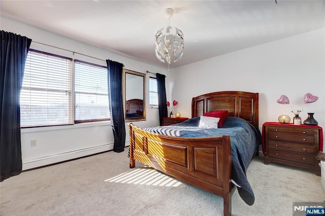 bedroom with an inviting chandelier, a baseboard heating unit, and light colored carpet