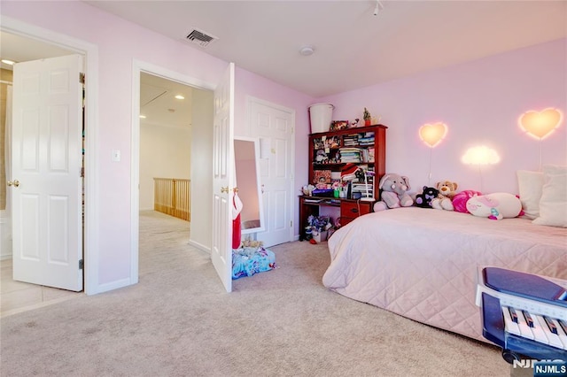 bedroom featuring light carpet