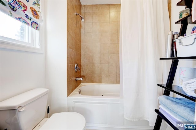 bathroom featuring toilet and shower / bath combo