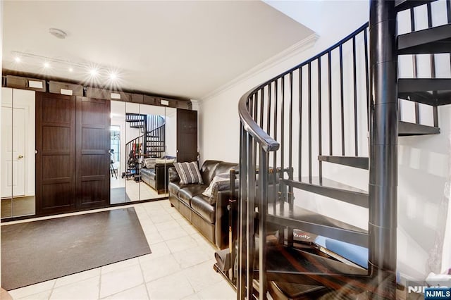 interior space with light tile patterned floors and ornamental molding