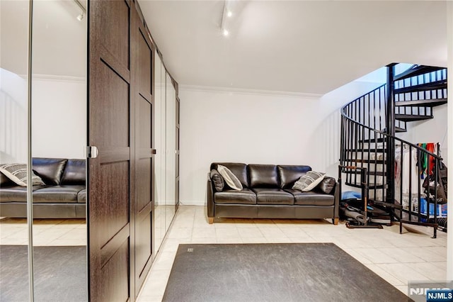 living room with ornamental molding, rail lighting, and light tile patterned floors