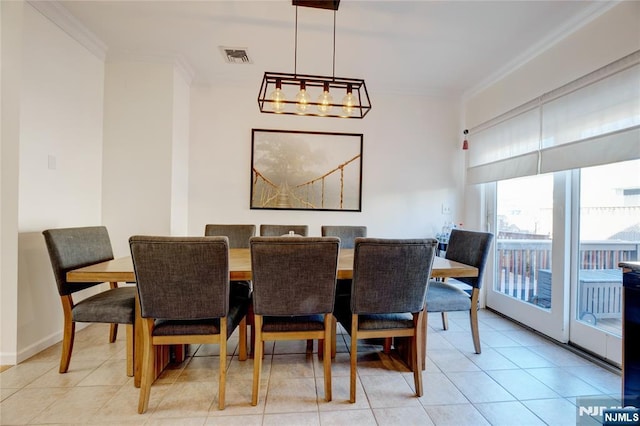 tiled dining space featuring crown molding