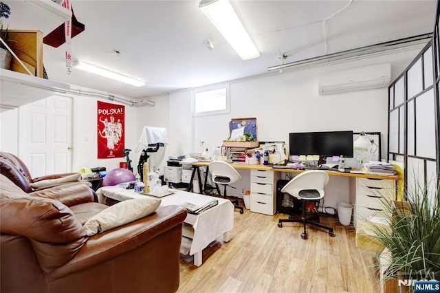 home office with hardwood / wood-style floors and a wall unit AC