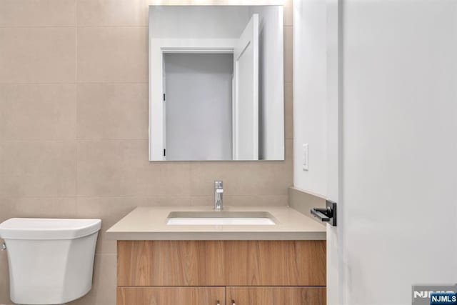 bathroom featuring toilet and vanity