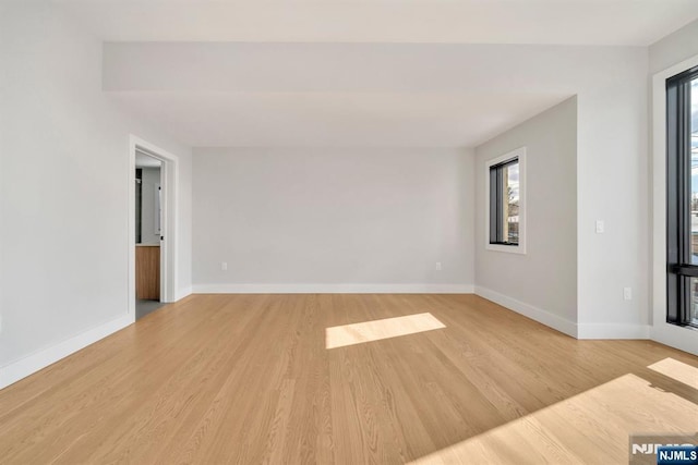 spare room with light hardwood / wood-style flooring