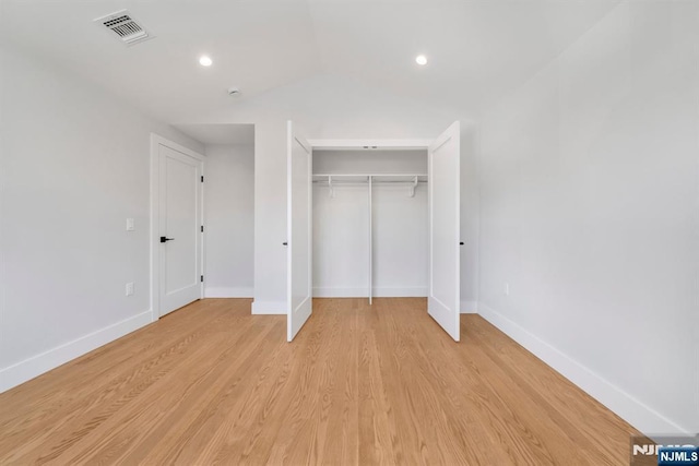 unfurnished bedroom with a closet and light hardwood / wood-style floors