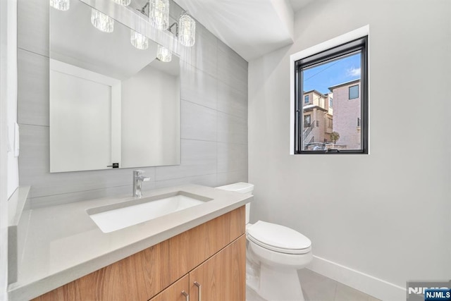 bathroom with backsplash, tile walls, vanity, toilet, and tile patterned floors