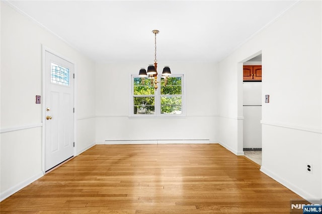 unfurnished dining area with a baseboard heating unit, light wood-style flooring, a notable chandelier, and plenty of natural light