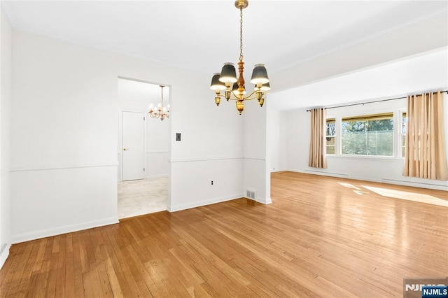 interior space featuring visible vents, baseboards, an inviting chandelier, light wood-style floors, and a baseboard heating unit