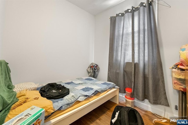 bedroom with hardwood / wood-style flooring