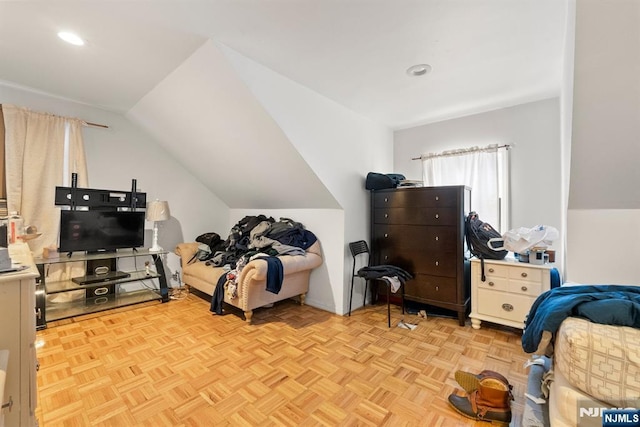 bedroom featuring vaulted ceiling and light parquet floors