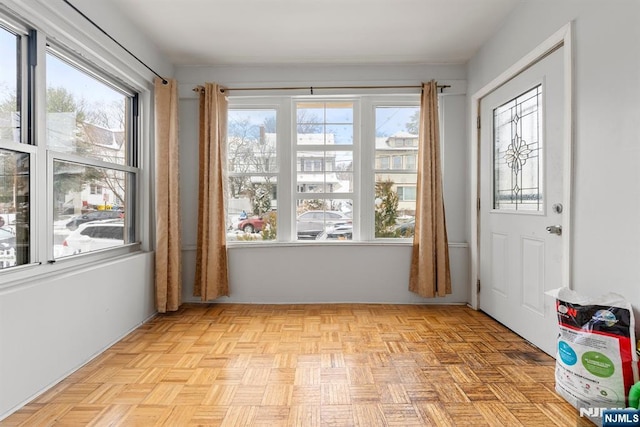 doorway to outside featuring light parquet flooring and a wealth of natural light