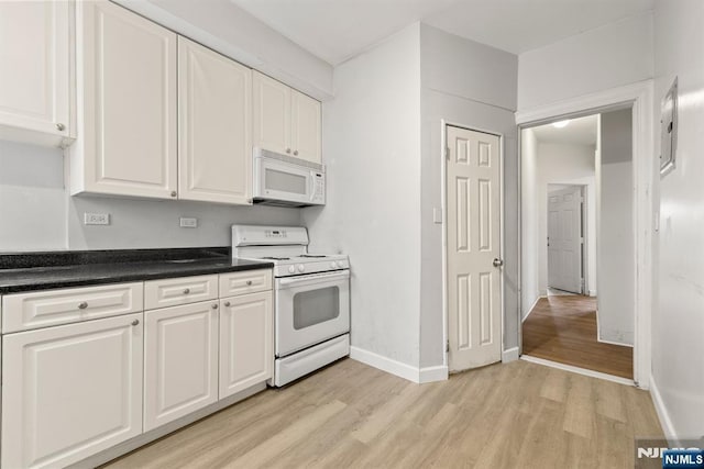 kitchen with white cabinetry, light wood-type flooring, and white appliances