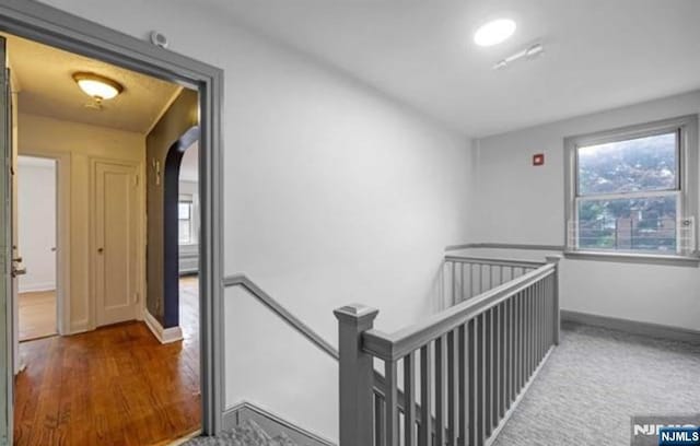 corridor with hardwood / wood-style floors