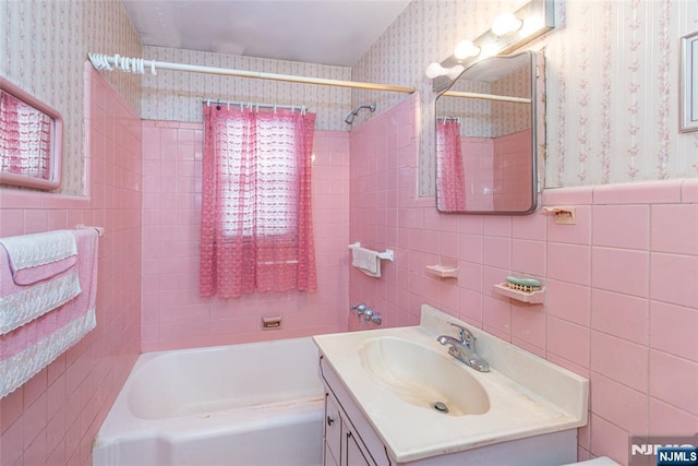 bathroom with vanity and tile walls