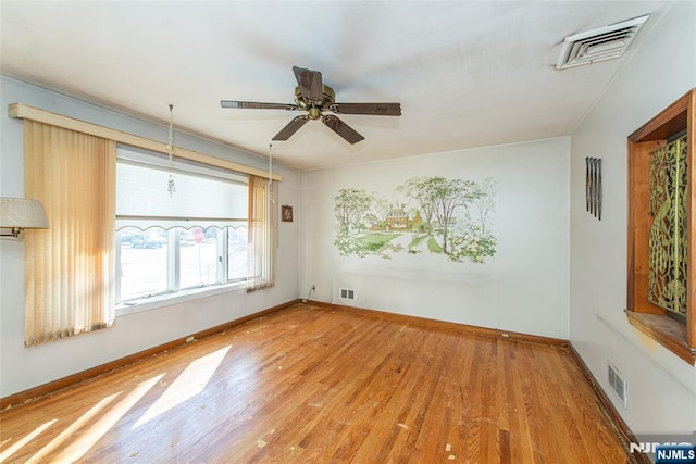 unfurnished room with hardwood / wood-style floors and ceiling fan