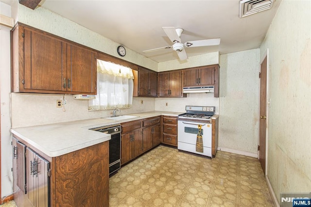 kitchen featuring sink, gas range gas stove, ceiling fan, black dishwasher, and kitchen peninsula