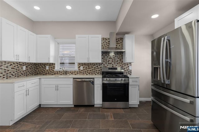 kitchen featuring white cabinets, stainless steel appliances, and wall chimney exhaust hood