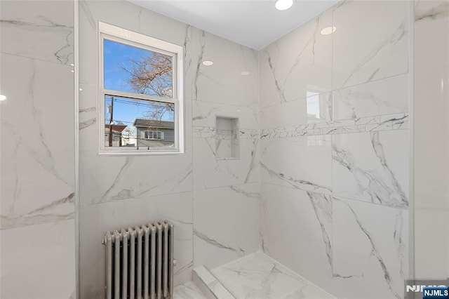 bathroom with walk in shower and radiator heating unit