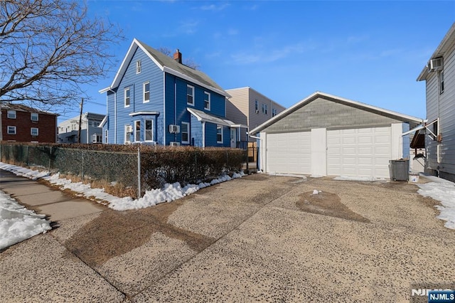 view of front of house featuring an outdoor structure and a garage