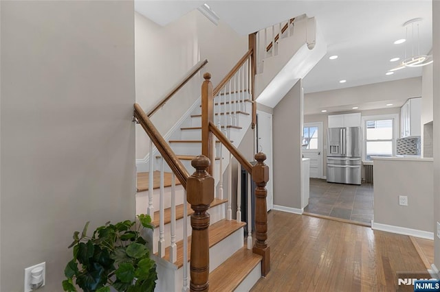 stairway with hardwood / wood-style floors