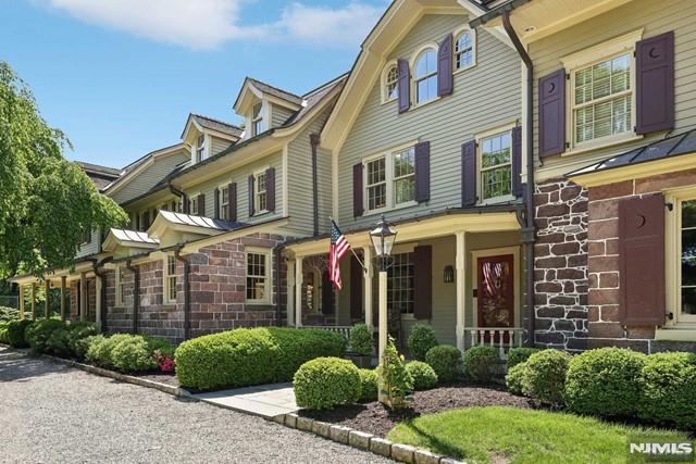 view of front of property featuring stone siding and covered porch