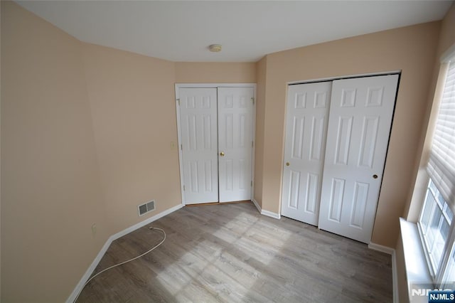 unfurnished bedroom with light hardwood / wood-style flooring