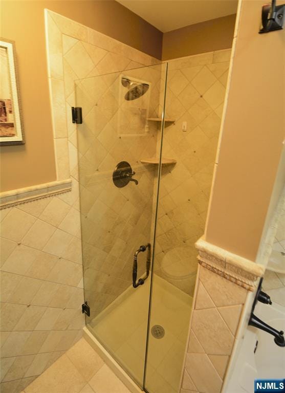 bathroom featuring an enclosed shower and toilet